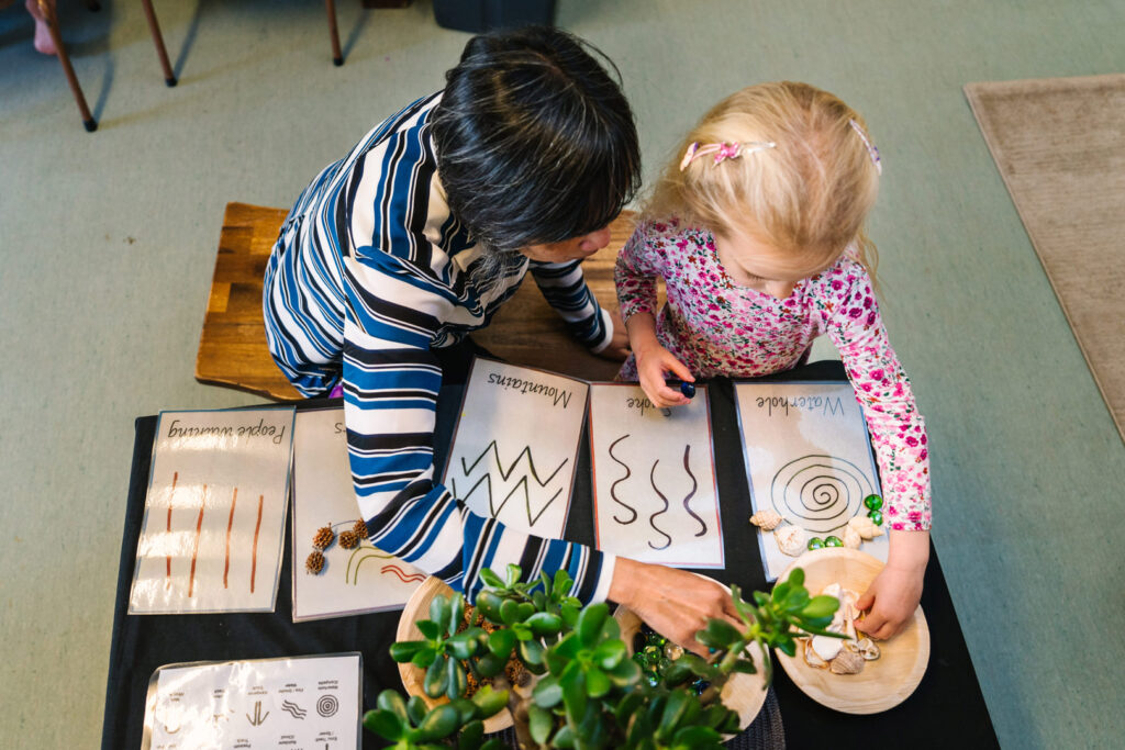 KU Bel Air childcare educator doing arts and craft with a child