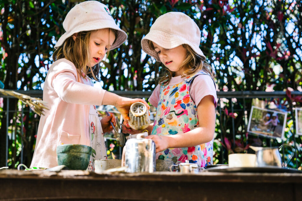 Children playing in the outdoor kitchen at KU Bel Air childcare