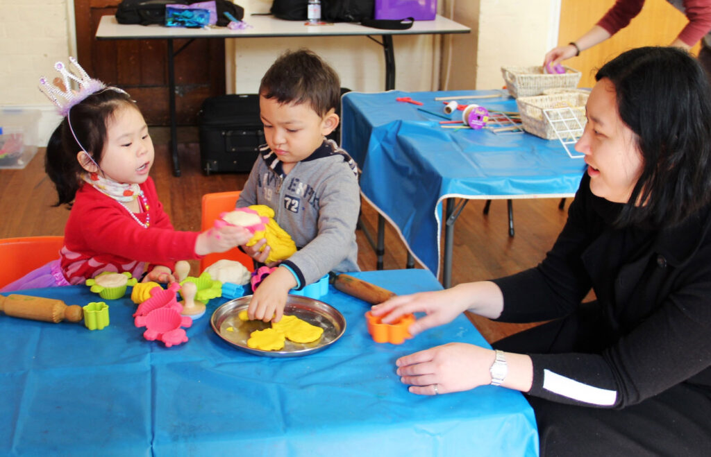 KU IWSP Ashfield childcare educator and children playing with playdough