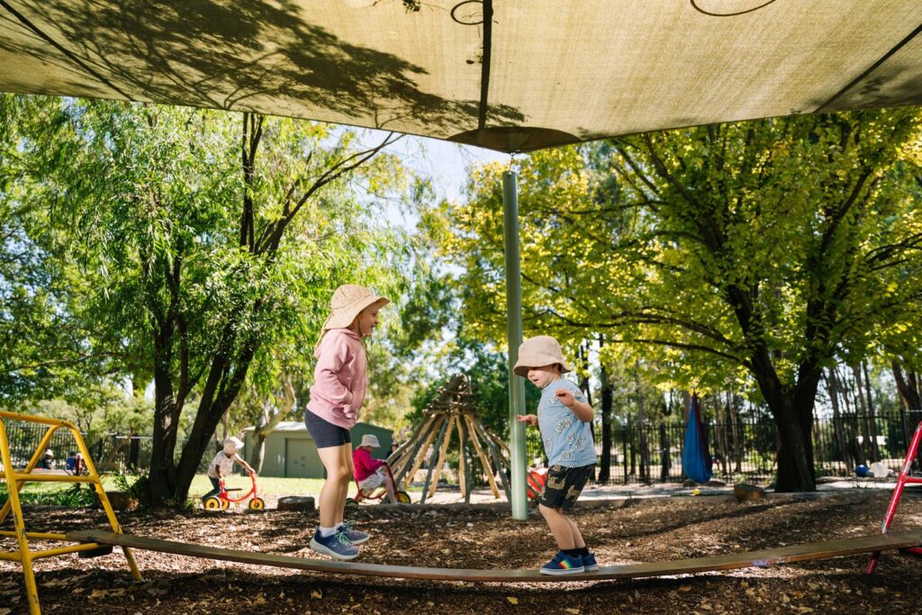 Children on a balance beam at KU Ashmont childcare