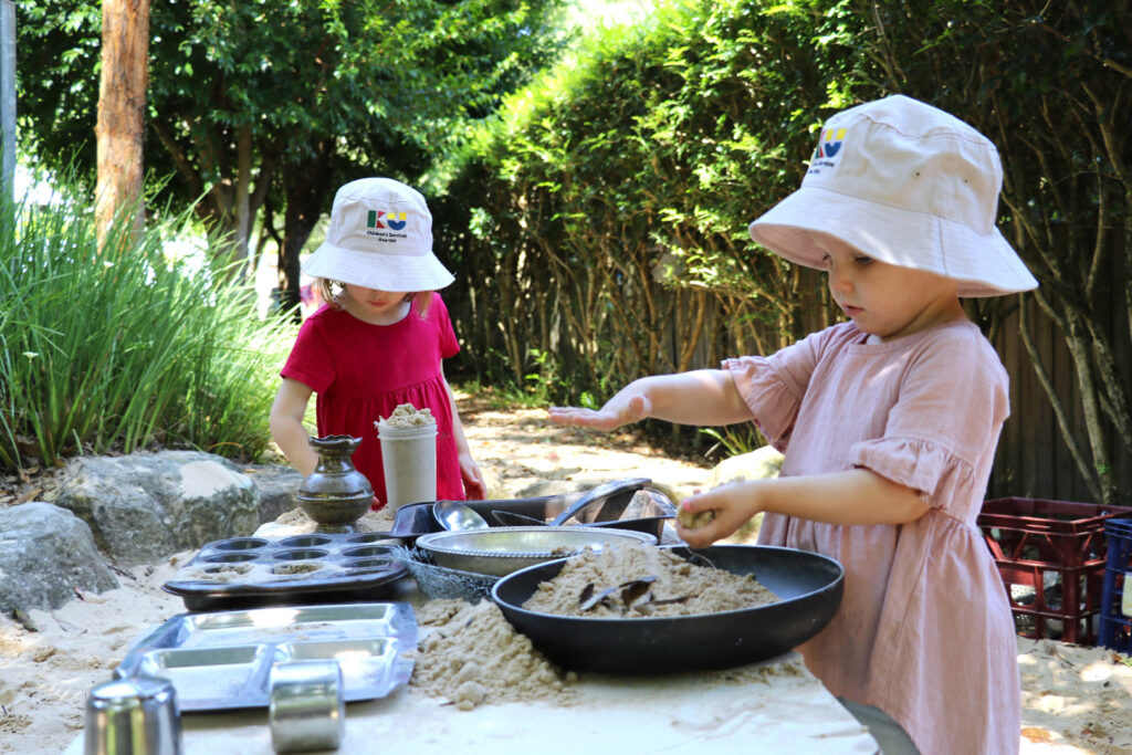 Children playing in the outdoor kitchen at KU Avalon childcare