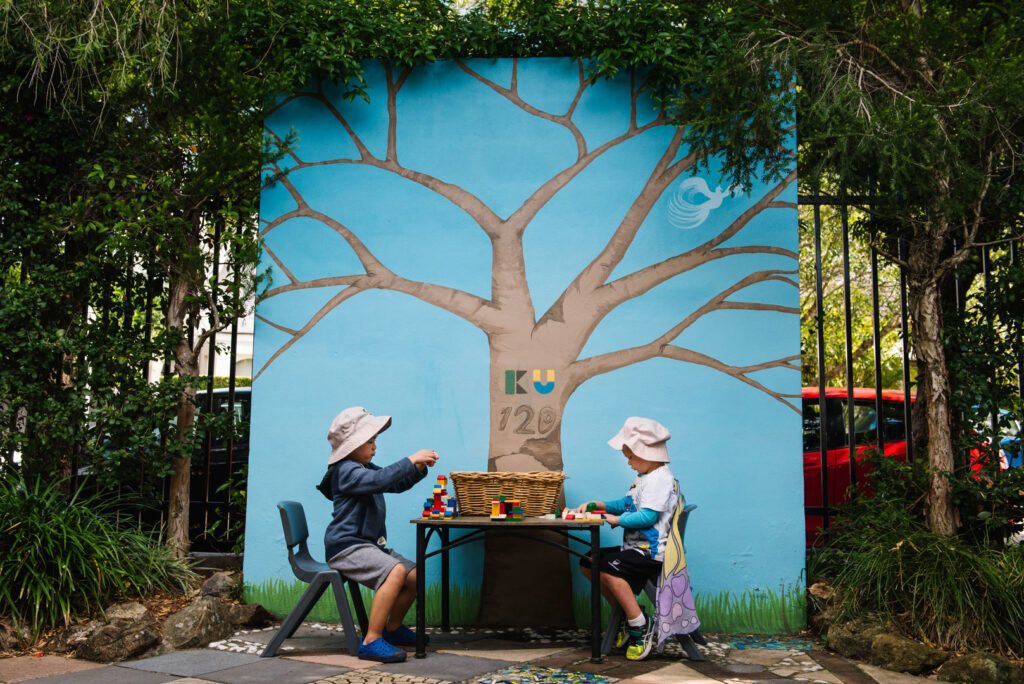 Children building with Lego outdoors at KU Phoenix childcare