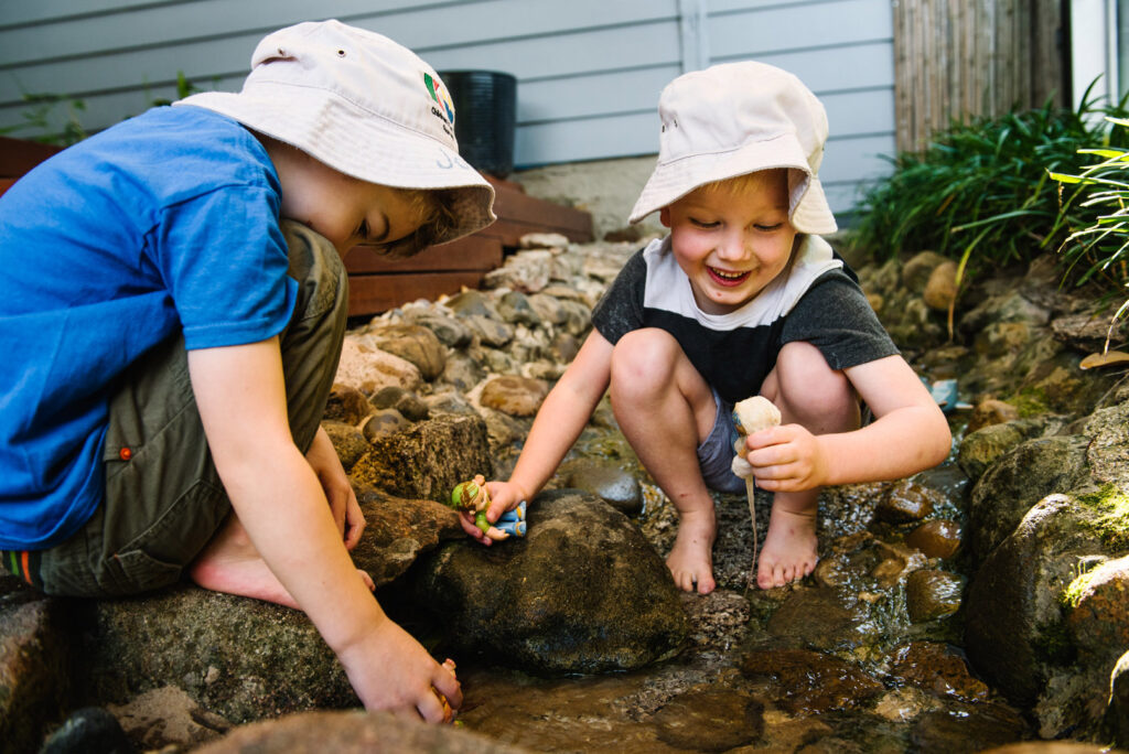 Children playing in the water at KU Phoenix childcare