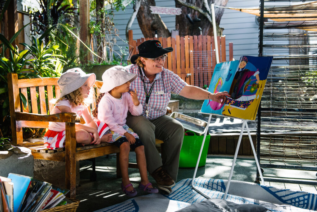 KU Phoenix childcare educator reading to children