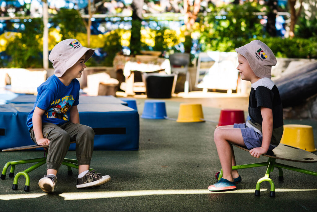 Children interacting outdoors at KU Phoenix childcare