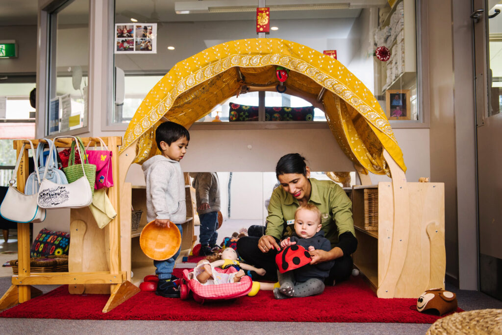 KU Village Green childcare educator interacting with children