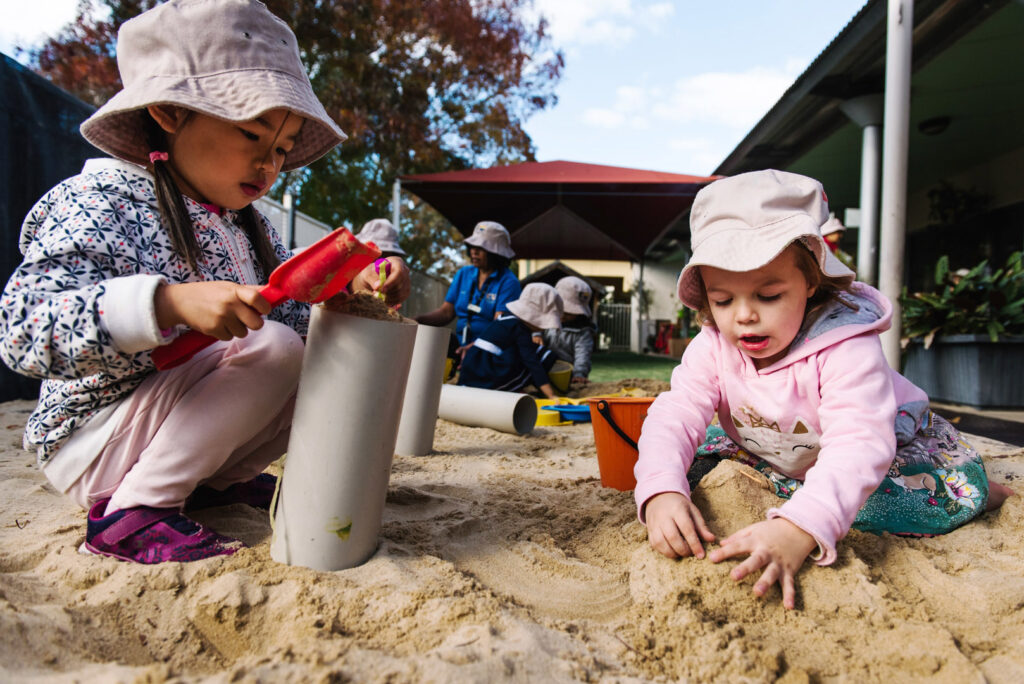 Children playing in the sand at KU Village Green childcare