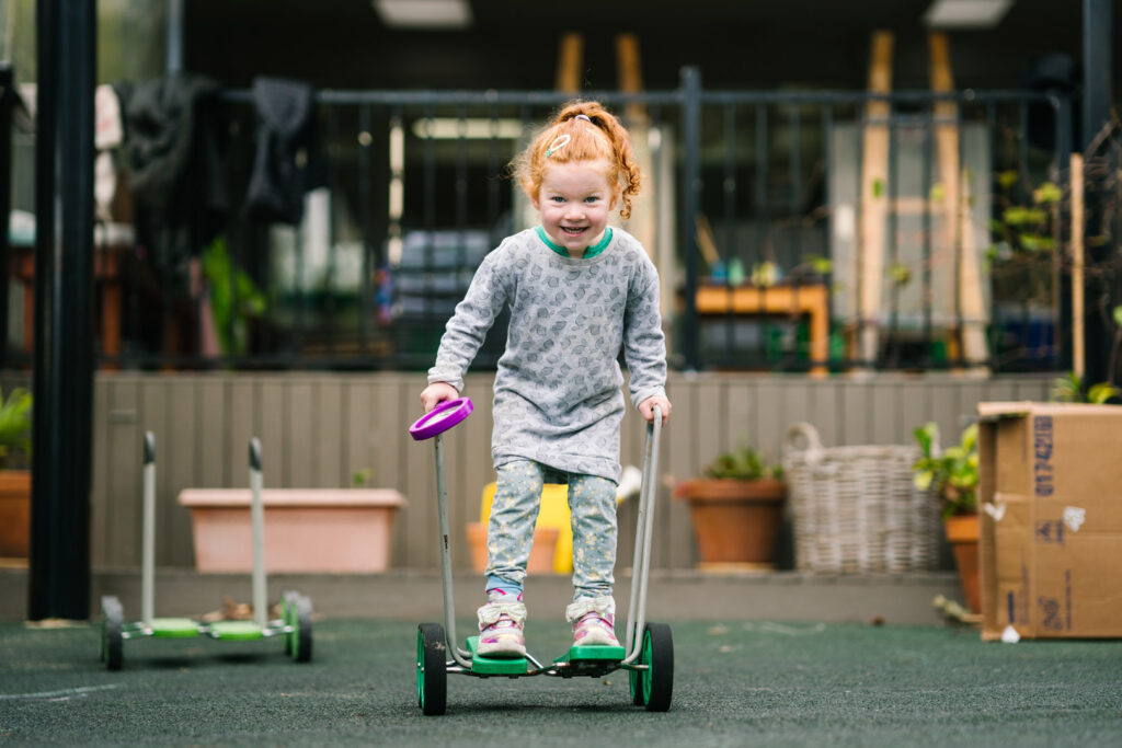 Child playing outdoors at KU Berowra childcare