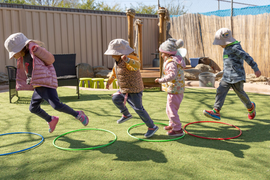 Children playing outdoors at KU Braddon childcare