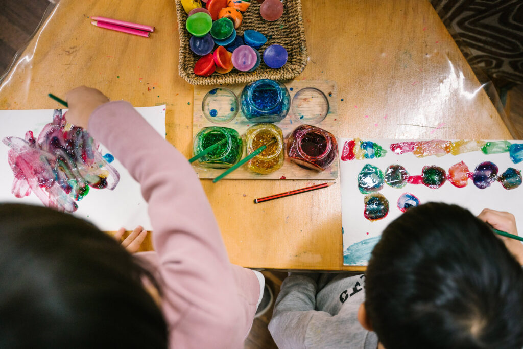 Children doing some painting at KU Cabramatta AMEP childcare