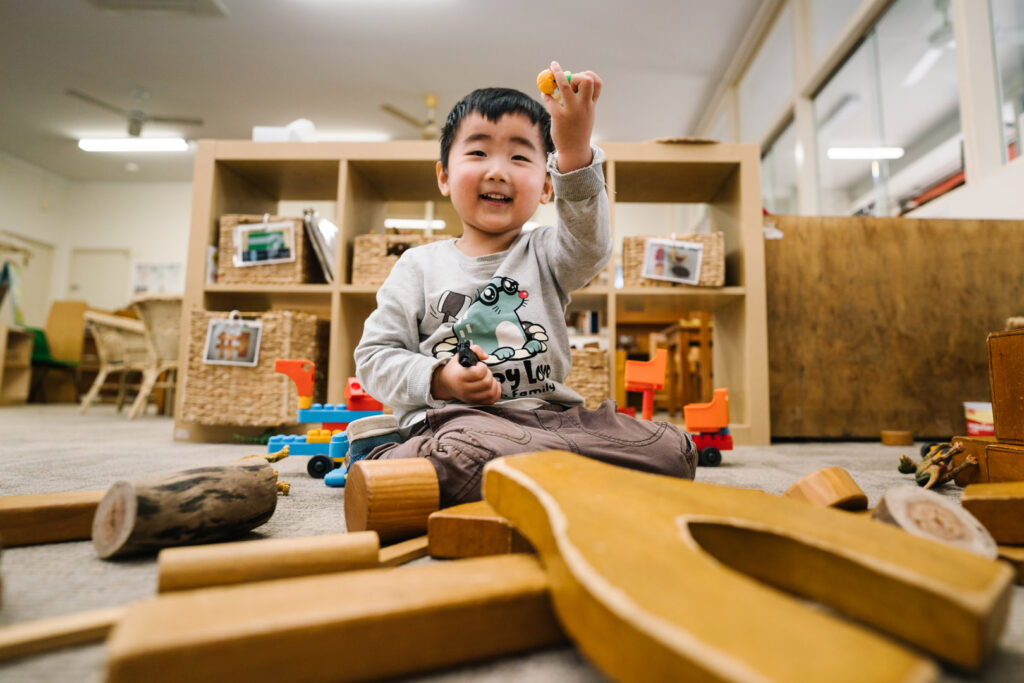 Child playing with blocks at KU Cabramatta AMEP childcare