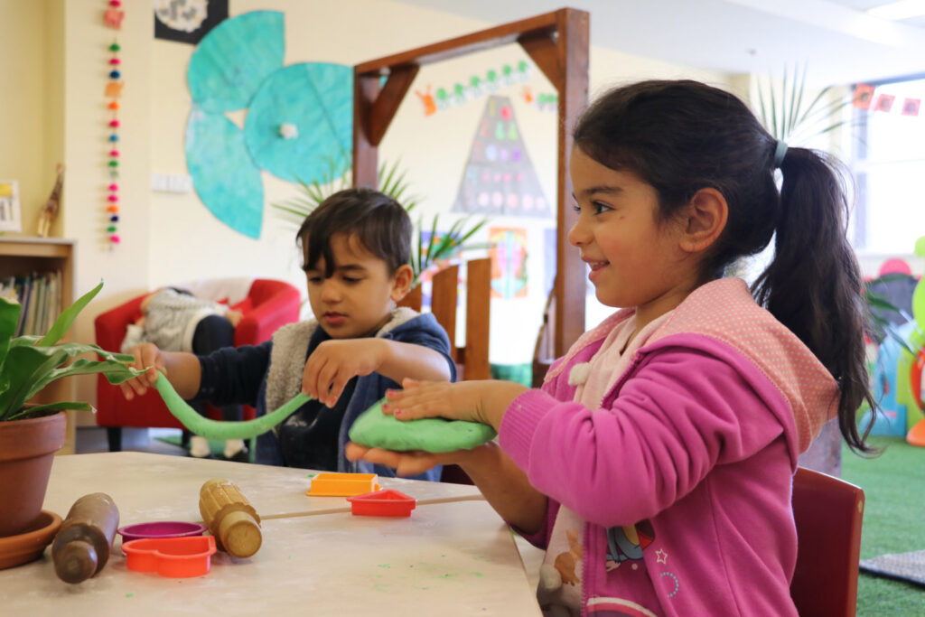 Children sculpting with playdough at KU Canberra City AMEP childcare