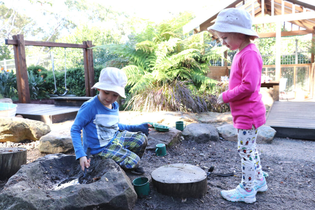 Children playing outdoors at KU Castlecrag childcare