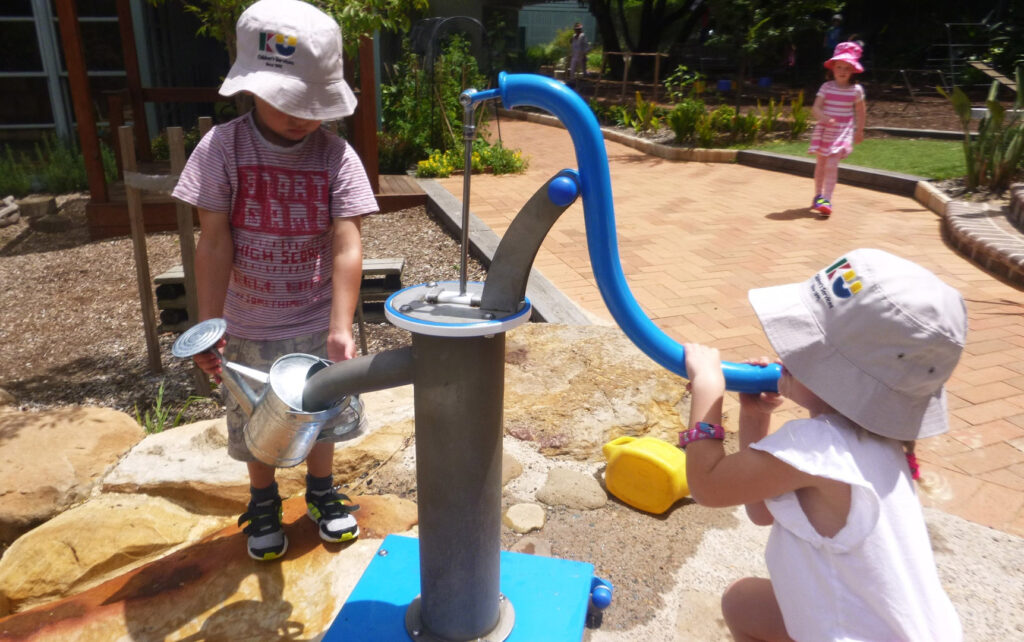 Children playing with a water feature at KU Castlecrag childcare