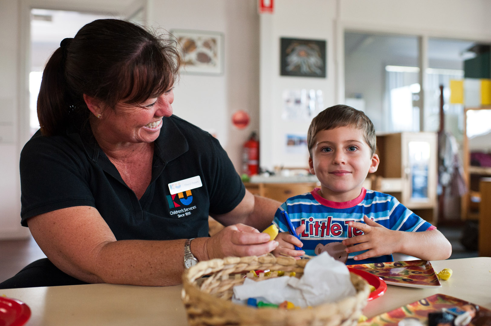 KU Corrimal East childcare educator interacting with a child