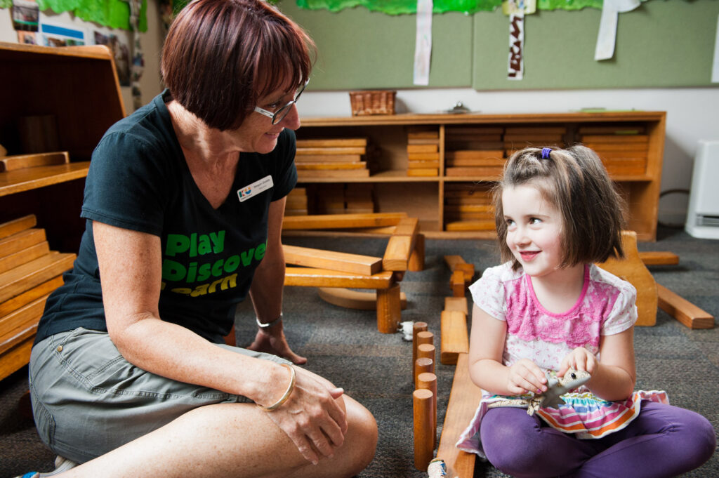 KU Corrimal East childcare educator interacting with a child