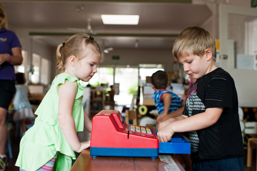 Children playing with a cash register at KU Corrimal East childcare