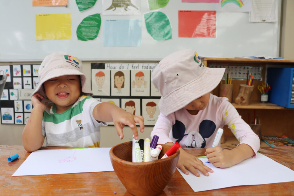 Children drawing pictures at KU Eastwood childcare