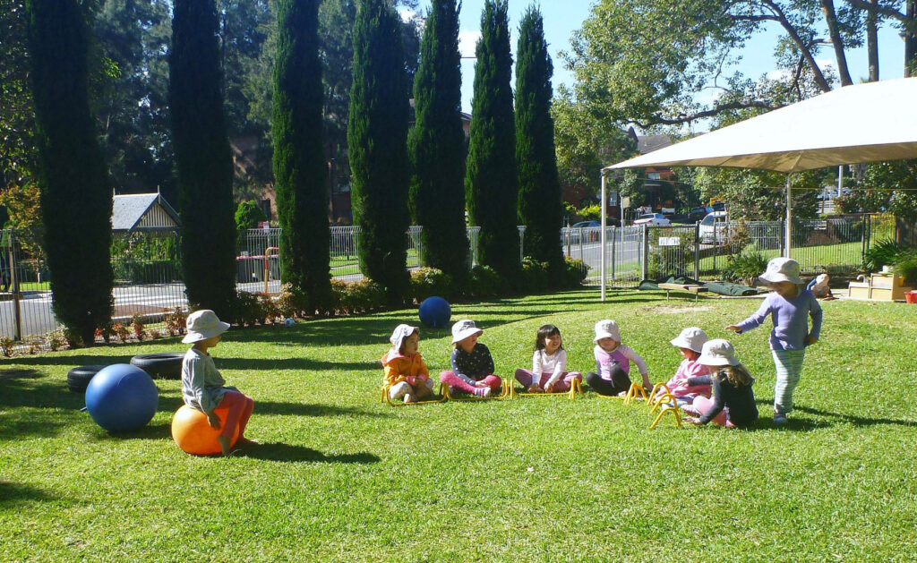 Children outdoors at KU Isobel Plus Memorial childcare