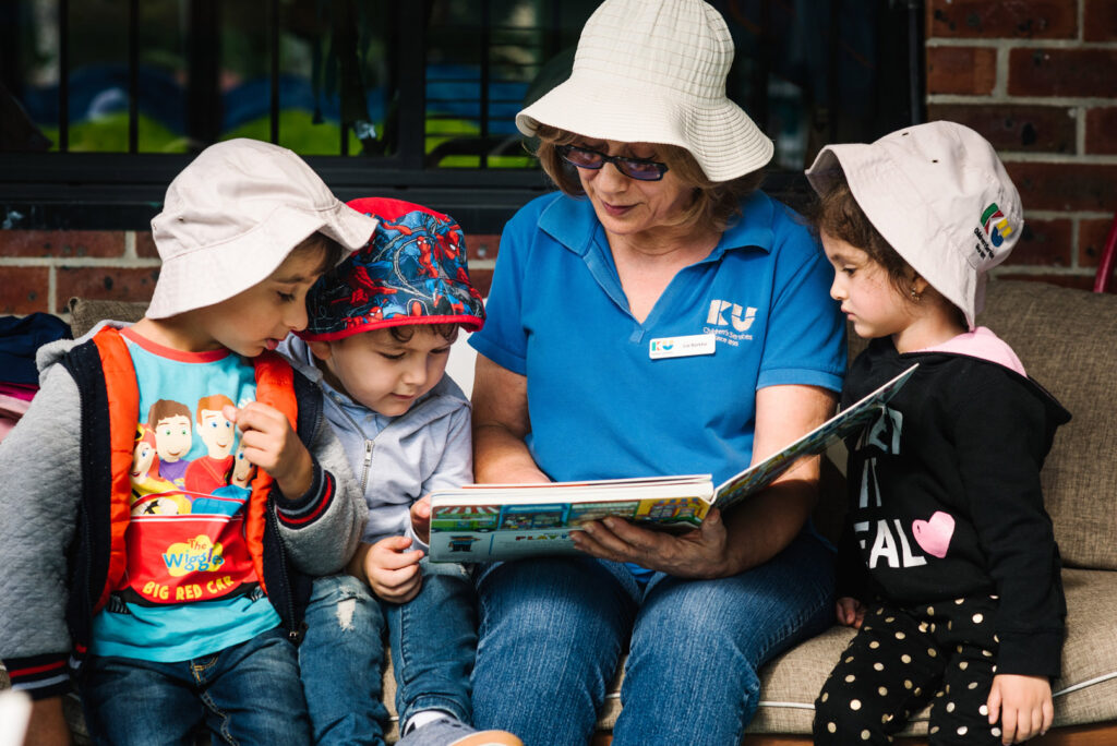 KU Fairfield AMEP childcare educator reading a story to children