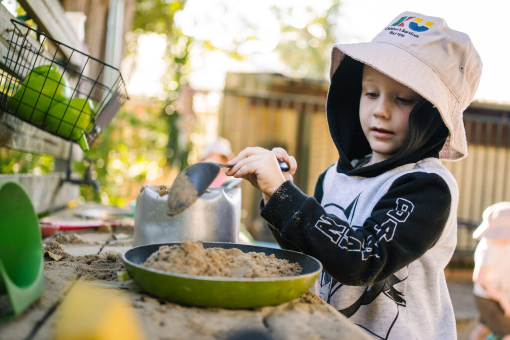 Child pretending to cook at KU Faulconbridge childcare