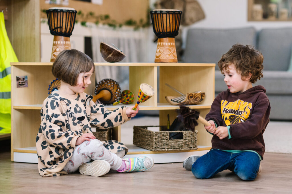 Children playing with musical instruments at KU Monash childcare