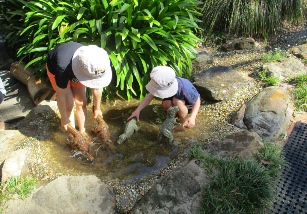 Children playing outdoors at KU Galston childcare