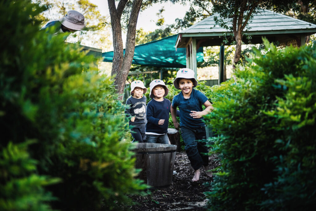 Children running outdoors at KU Karingal childcare