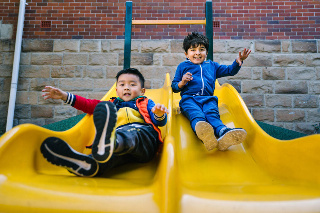 Children playing on the slides at KU Greenwich Community childcare