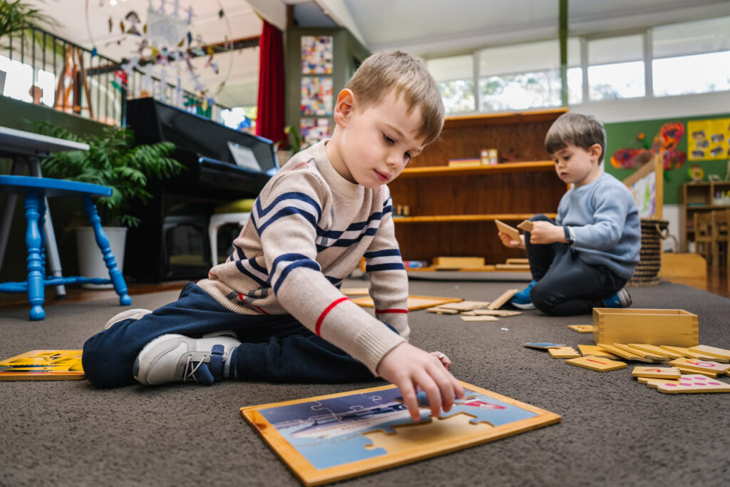 Children doing puzzles at KU Greenwich childcare