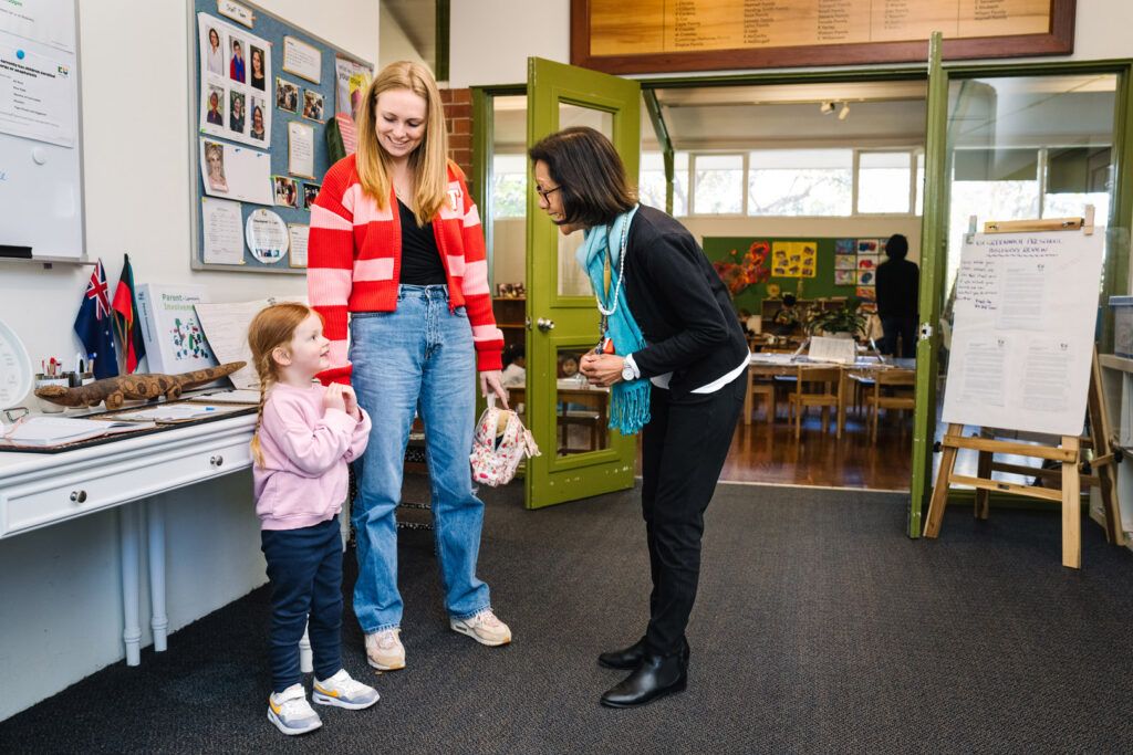 KU Greenwich childcare educator interacting with a child