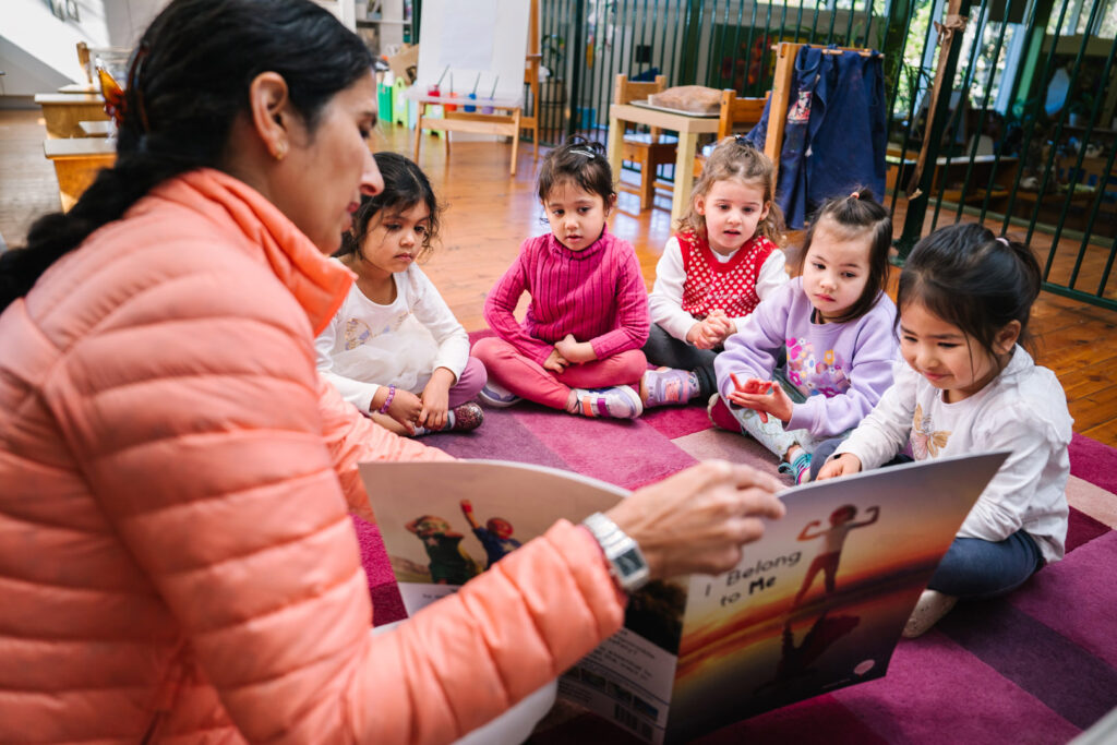 KU Greenwich childcare educator reading to children