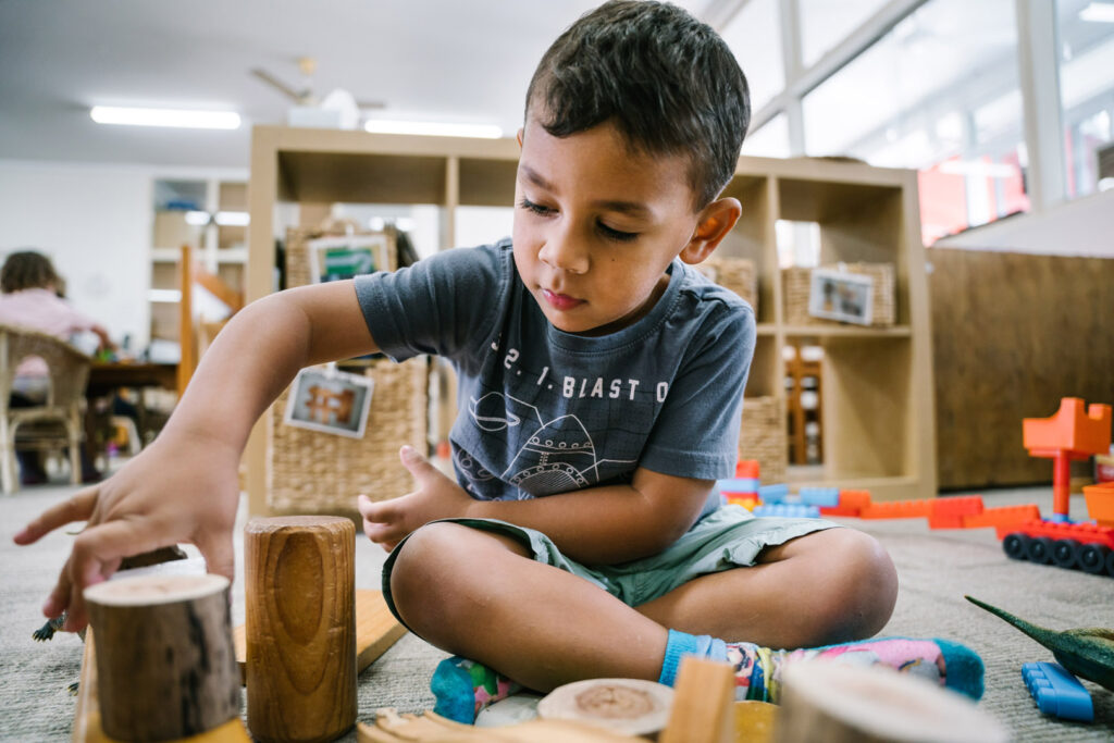 Child playing with blocks at KU Grevillea childcare