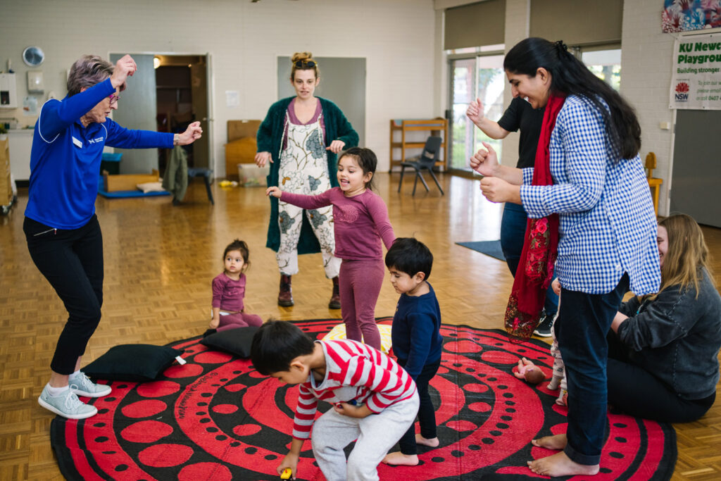 KU NSP Jesmond Neighbourhood childcare educators and children dancing together