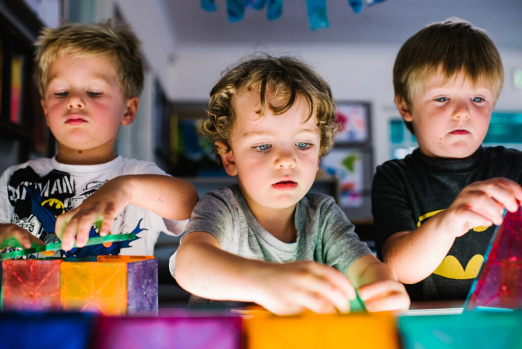 Children playing with light up blocks at KU Killara Park childcare