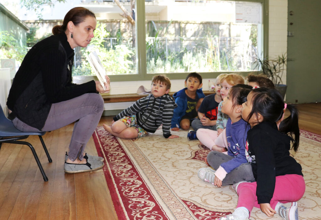 KU Killarney Heights childcare educator reading to children