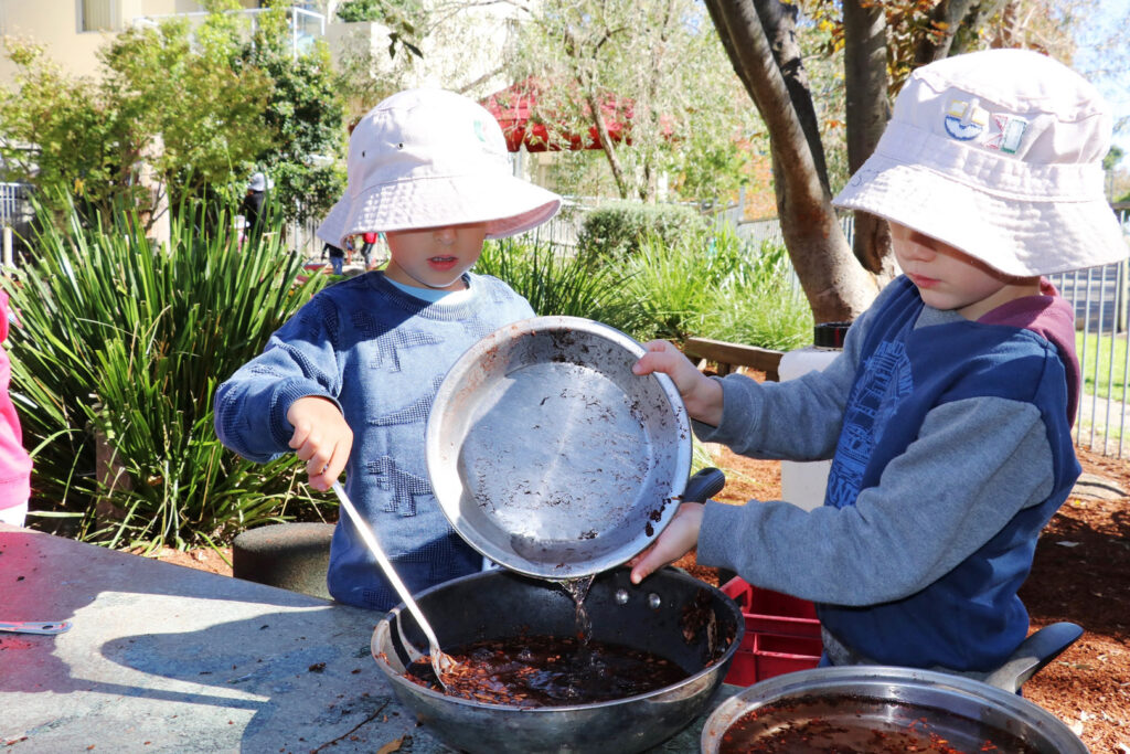 Children cooking in an outdoor kitchen