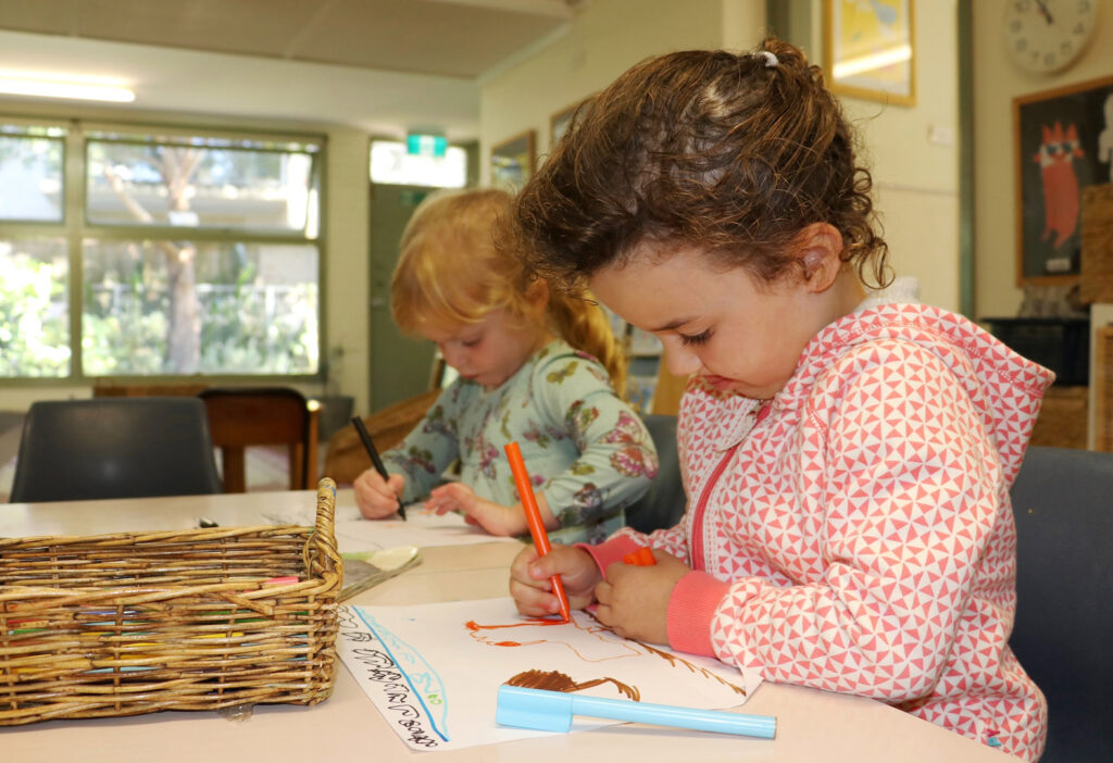 Children drawing pictures at KU Killarney Heights childcare