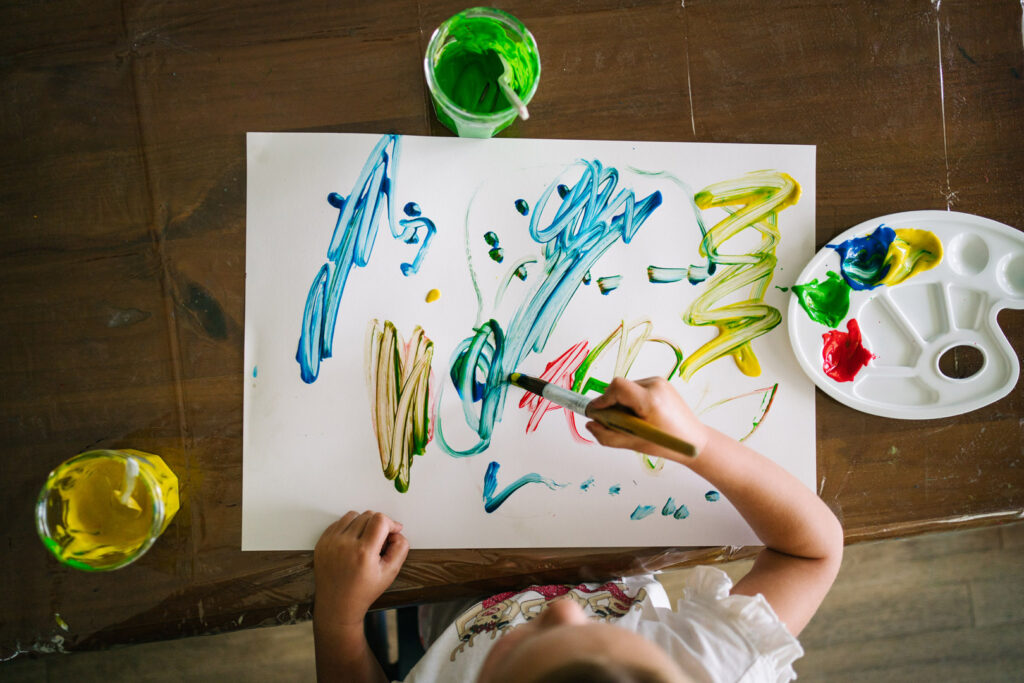 Child doing a painting at KU Peter Pan La Perouse childcare