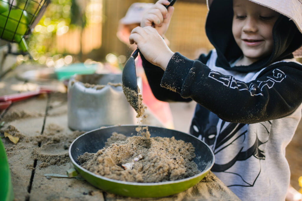 Child pretending to cook at KU Peter Pan La Perouse childcare