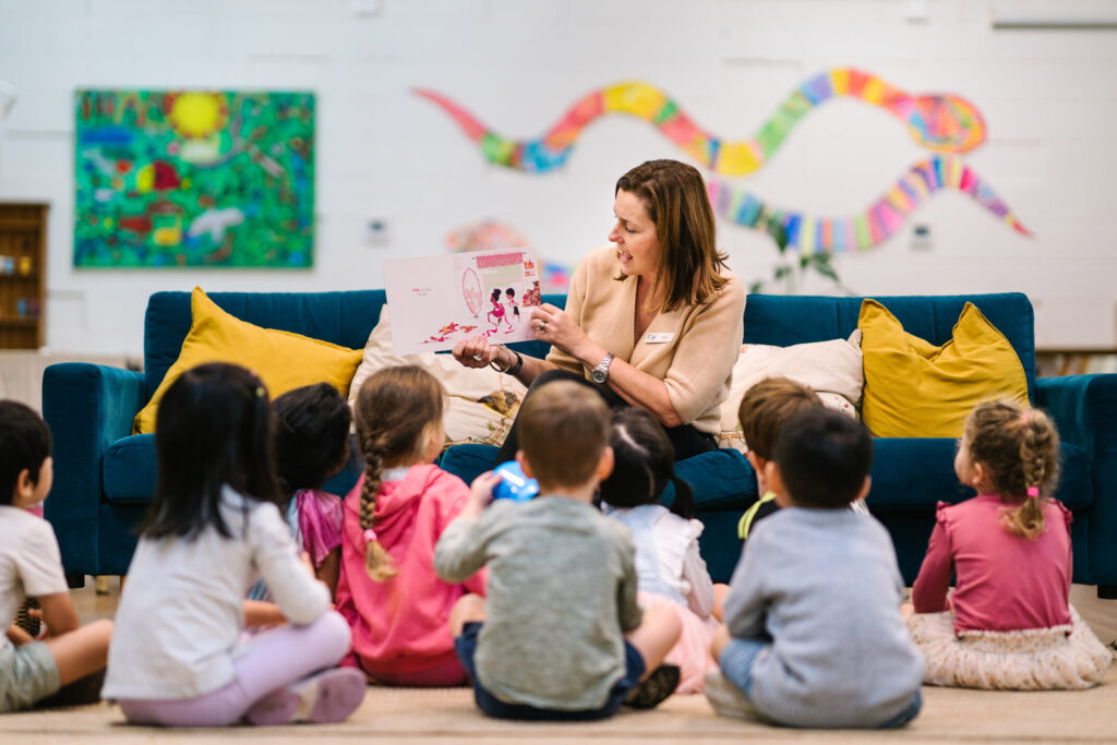 KU Osborne childcare educator reading a story to children