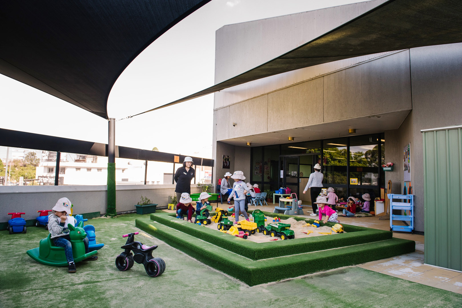 KU Liverpool AMEP childcare educators supervising children outdoors