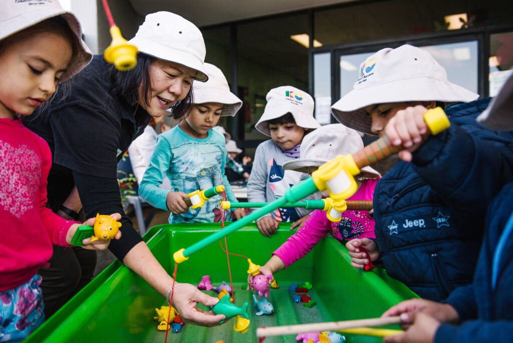 KU Liverpool AMEP childcare educator and children pretending to fish