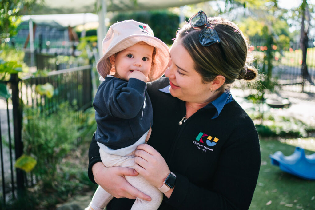 KU ANSTO childcare educator interacting with a child