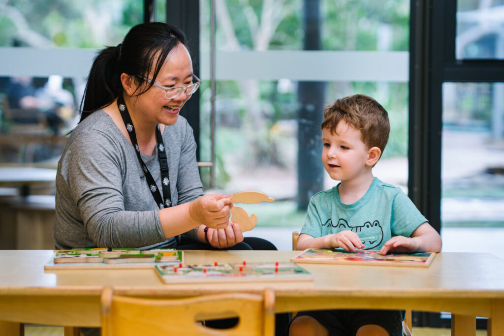 KU ANSTO childcare educator interacting with a child