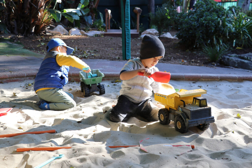 Children playing in the sand at KU Crusader childcare