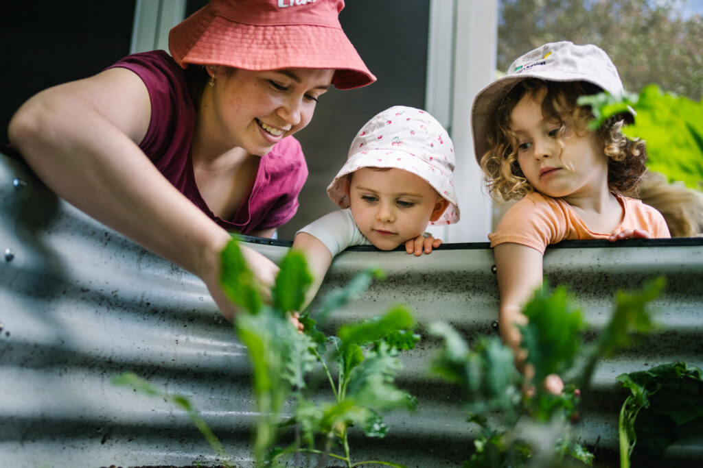 KU Mayfield childcare educator gardening with some children