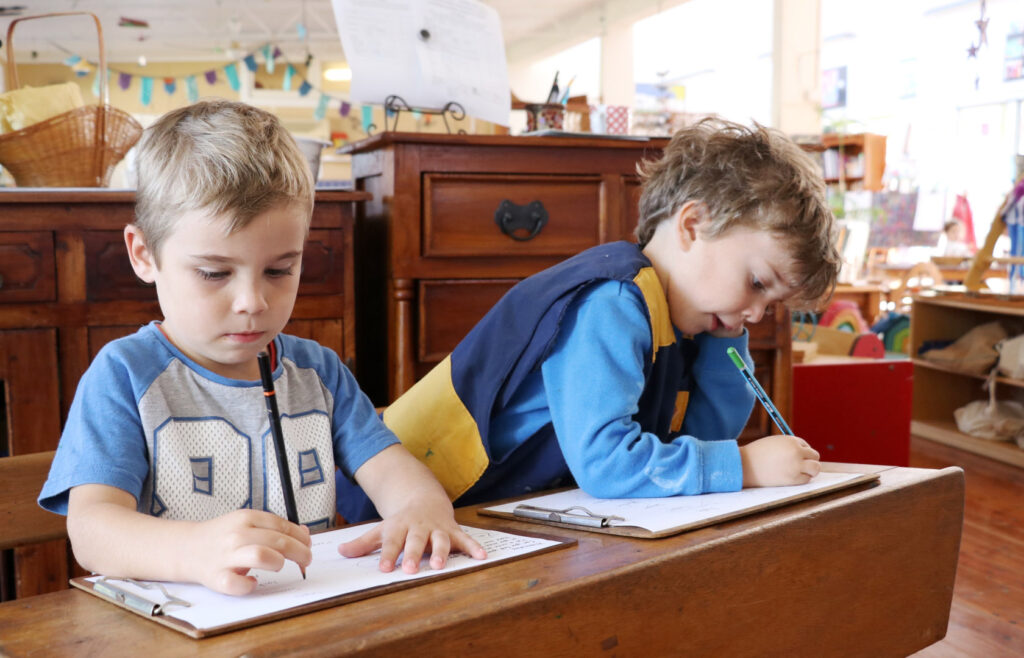 Children doing some writing at KU Merewether childcare