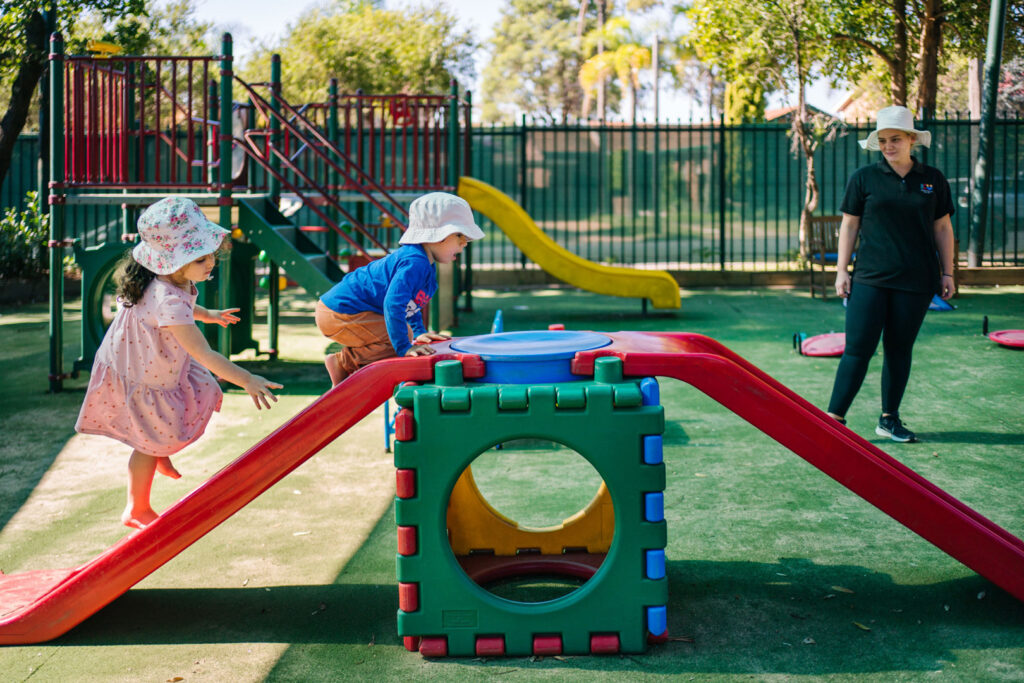 Children playing on the equipment at KU Merewether childcare