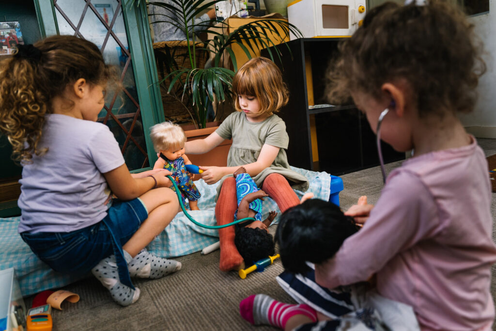 Children playing with dolls at KU Carillon Avenue childcare